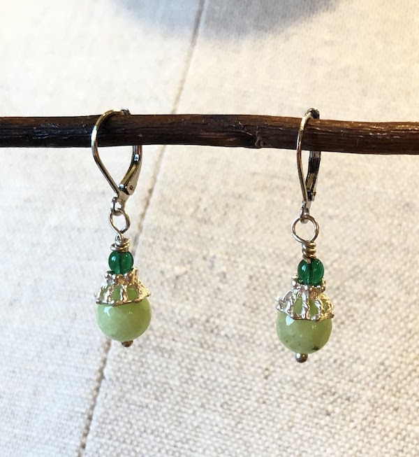 Light green colored, semi precious gem stones wire wrapped with a green glass bead. All hardware is stainless steel and plated sterling.