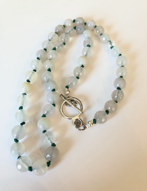 Gray semi-translucent beads, hand knotted on green silk