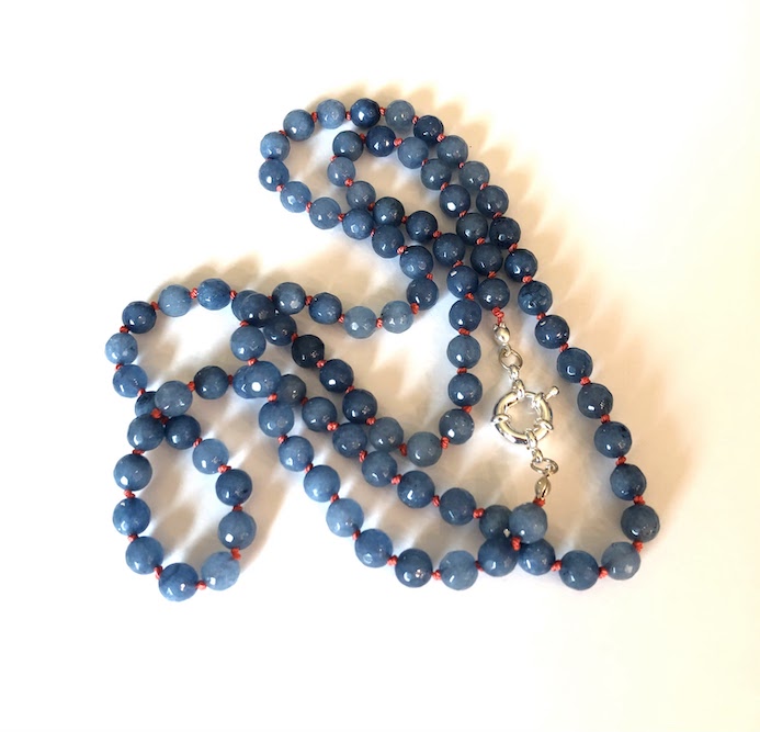 Sapphire blue faceted jade gemstone necklace, hand knotted on coral orange silk and finished with silver clasp.