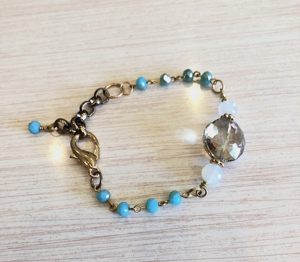 Turquoise blue glass bead chain is wire wrapped on brass with opalite accents.