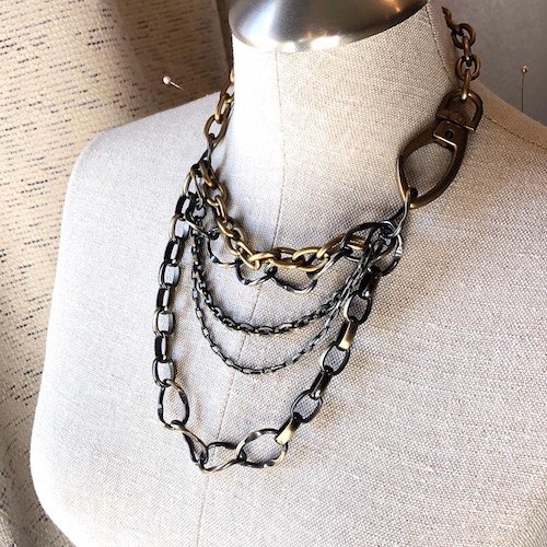 Multi chain necklace featuring all aged and antiqued brass. Extra large side clasp.