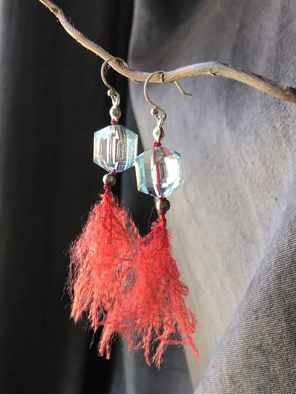 These earrings feature pale blue cathedral cut, (faceted cubes), hand knotted on red silk and finished with sterling silver hooks.