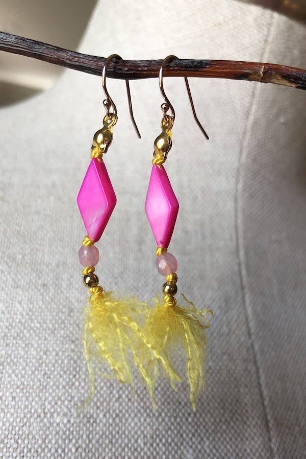 Vibrant fuschia shell beads knotted on 100% yellow silk.