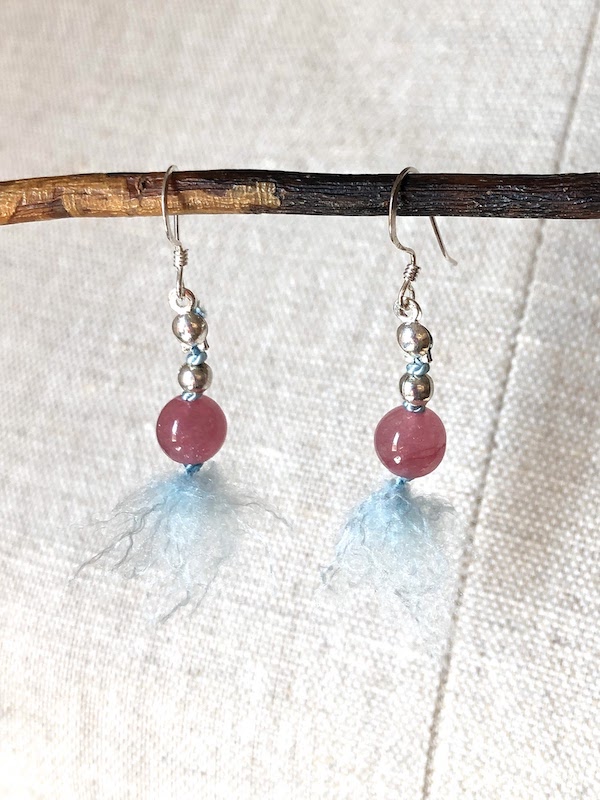 Rose pink, smooth jade beads, hand knotted on light blue silk and finished with sterling silver earring hooks.