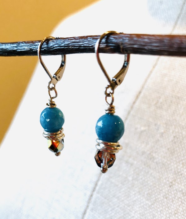 Turquoise blue colored, semi precious gem stones wire wrapped with Czech glass bead.  All hardware is stainless steel and plated sterling silver.