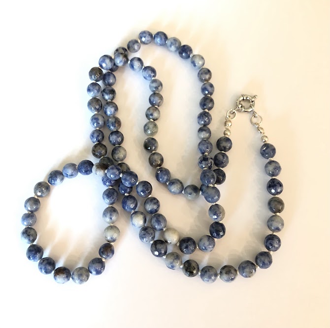 Blue sodalite, faceted gemstone necklace, hand knotted on white silk and finished with stainless steel clasp.