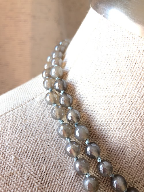 Medium, warm gray agate stone beads with “mystic” coating! This necklace is hand knotted on pale blue silk and is a continuous strand, no clasp.