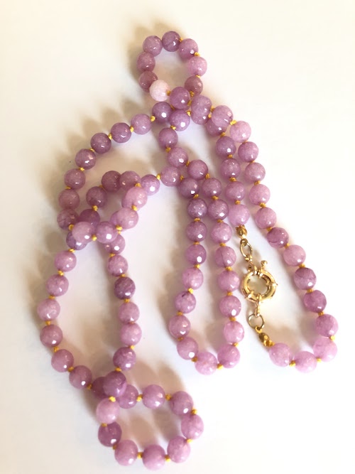Pale lavender-pink, faceted jade gemstone necklace, hand knotted on daisy yellow silk and finished with gold clasp.