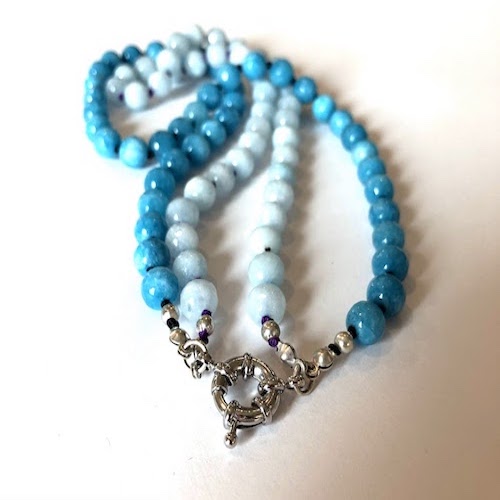 Turquoise/pale blue beads, hand knotted on black/purple silk