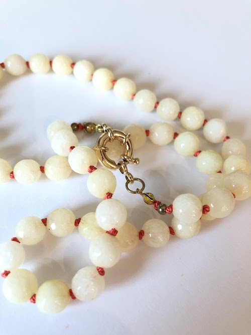 Yellow faceted jade gemstone necklace, hand knotted on orange silk and finished with a gold clasp.