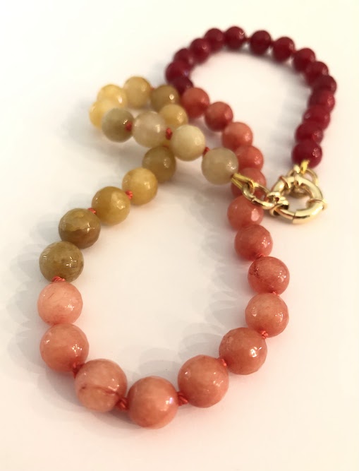 Yellow, Peach, and red faceted jade gemstone necklace, hand knotted on orange silk and finished with a gold clasp.